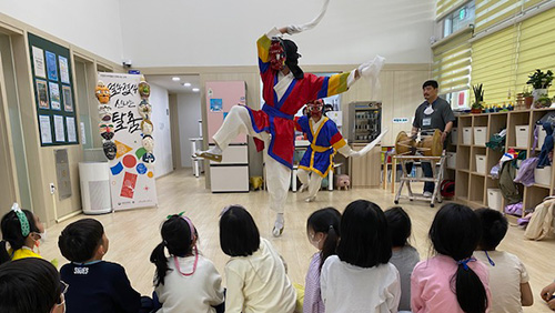 탈 춤 추는 모습을 보고 있는 아이들